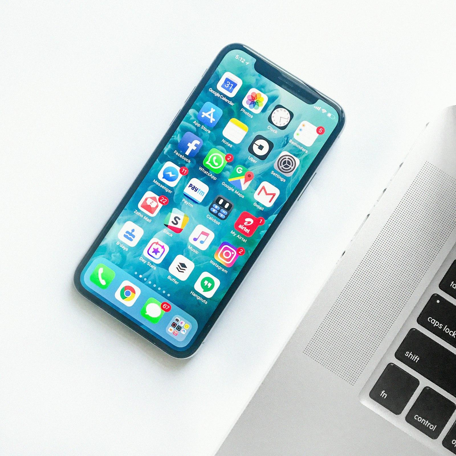 A workspace with a phone and a laptop